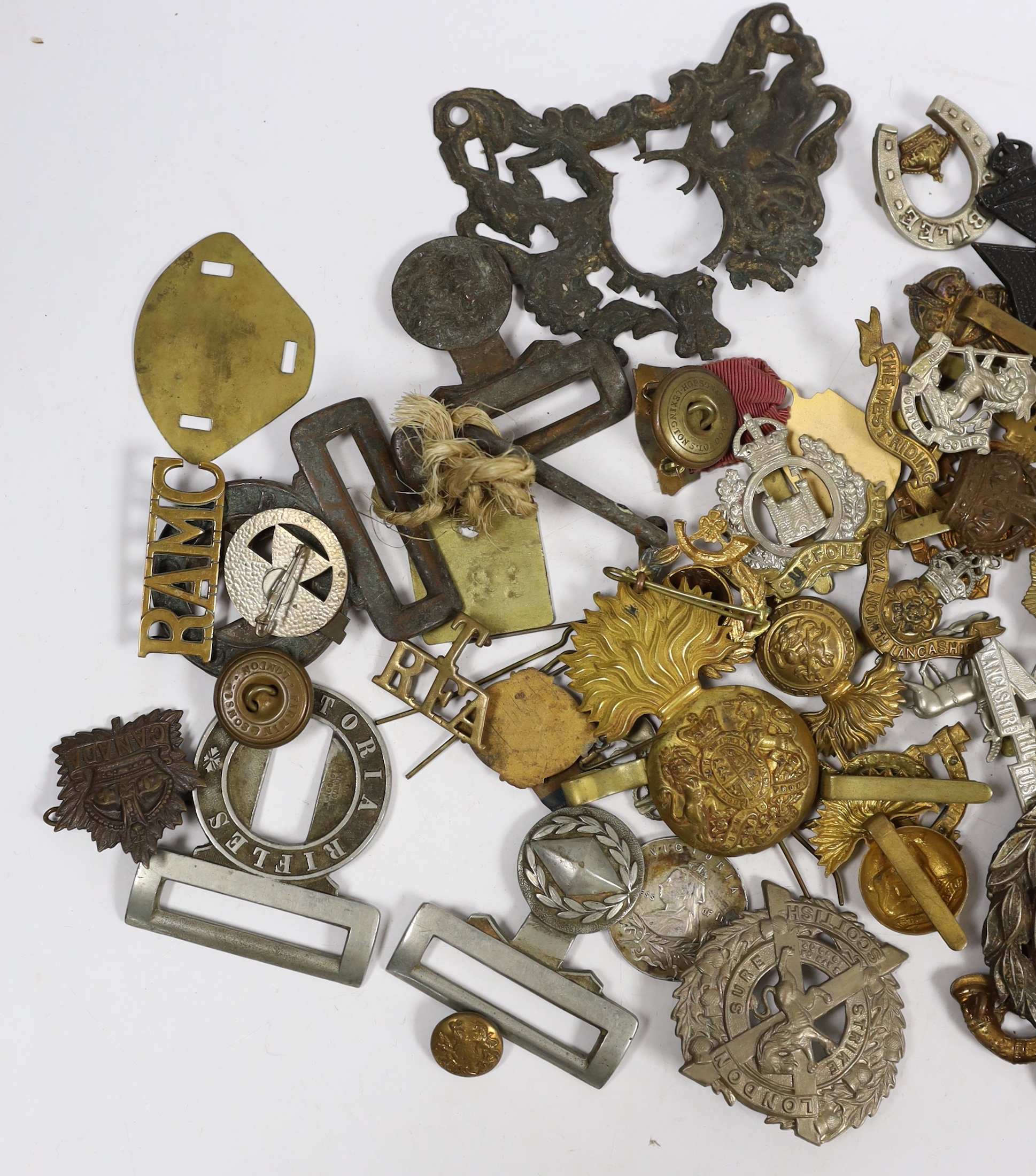 Eighteen military cap badges including Northumberland Fusiliers, East Yorkshire, SWB, the Suffolk Regiment, the Lancashire Fusiliers, Connaught Rangers, North Irish Horse, the West Riding, together with a number of shoul